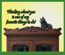 Tortoise Shell Cat the Top of on an Antique Cabinet
